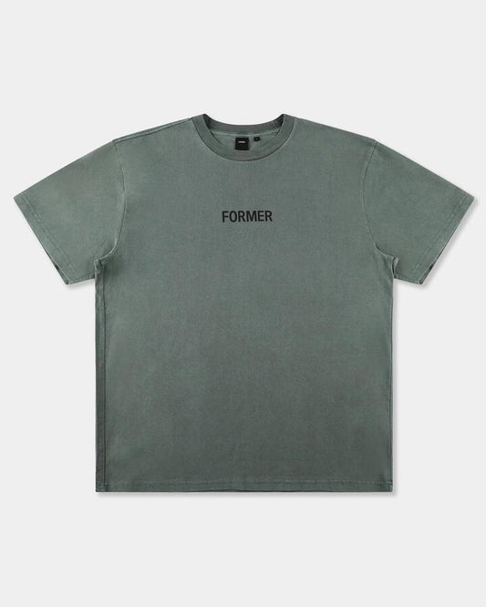 Image of a model wearing Tops. Productname: former Mens Legacy Overdye T-Shirt Pine - in Pine colour by brand - Former