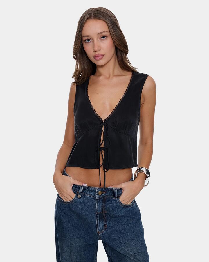 Image of a model wearing Tops. Product name - Thrills Womens Saige Tie Front Crop Top Black in Black colour by brand - Thrills