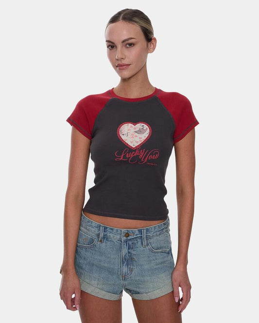 Image of a model wearing Tops. Productname: thrills Womens Lucky You Raglan Club T-Shirt Merch Black - in Merch Black colour by brand - Thrills