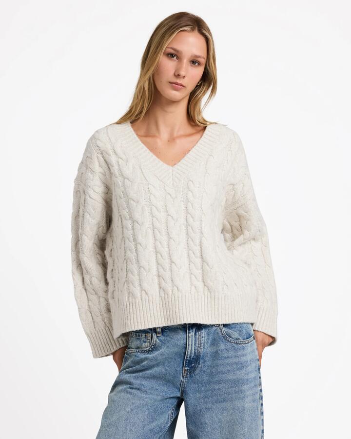Image of a model wearing Outerwear. Productname: rvca Womens Cable V Neck Sweater Star White - in Star White colour by brand - Rvca