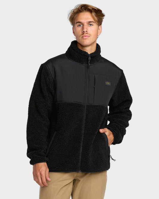 Image of a model wearing Outerwear. Product name - Billabong Mens Boundary Summit Mock Neck Fleece Top Black in Black colour by brand - Billabong