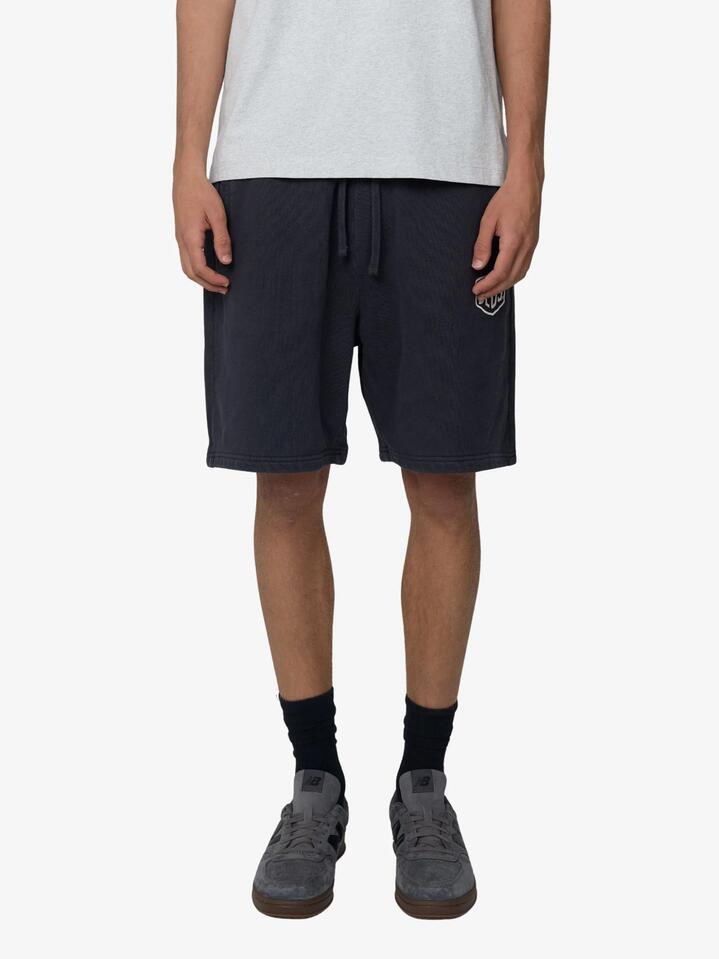 Image of a model wearing Shorts. Productname: Deus Shield Garment Dyed Track Shorts in Black colour by brand - Deus