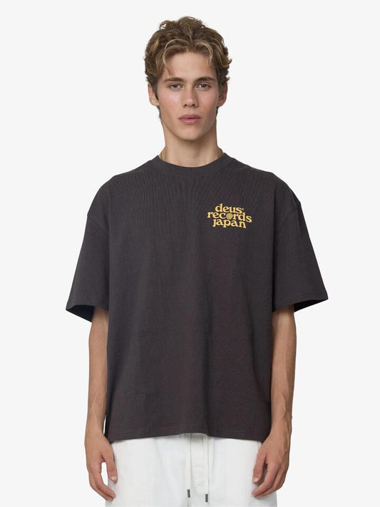 Image of a model wearing Tops. Productname: Deus Reverse Strata Tee in Anthracite colour by brand - Deus