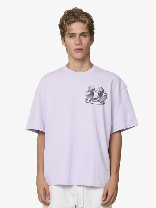 Image of a model wearing Tops. Productname: Deus Love Is All The Rage Tee in Orchid Hush colour by brand - Deus