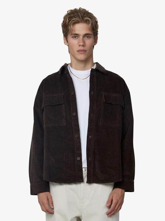 Image of a model wearing Outerwear. Productname: Article One Hunter Cord Overshirt in Chocolate colour by brand - Article One