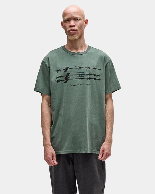 Image of a model wearing Tops. Productname: former Mens Primal T-Shirt Pine - in Pine colour by brand - Former