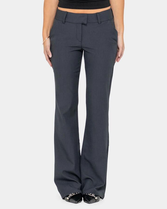 Image of a model wearing Pants. Productname: Rusty Womens Finance Mummy Low Rise Suit Pants Black - in Black colour by brand - Rusty