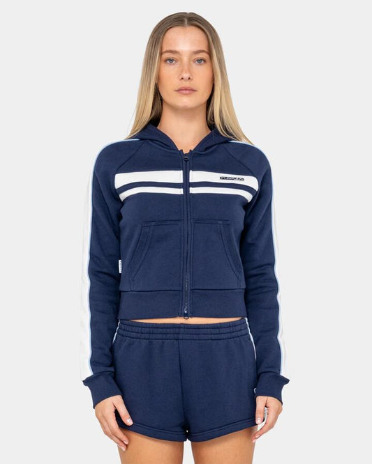 Image of a model wearing Outerwear. Productname: rusty Womens Retro Lines Zip Up Hoodie Navy Blue - in Navy Blue colour by brand - Rusty