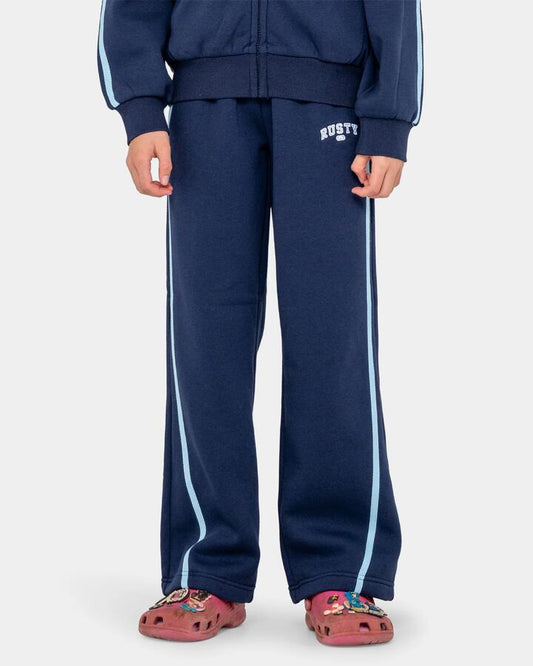 Image of a model wearing Pants. Productname: rusty Girls 8-16 Girls Team Varsity Wide Leg Jogger Pants Navy - in Navy colour by brand - Rusty