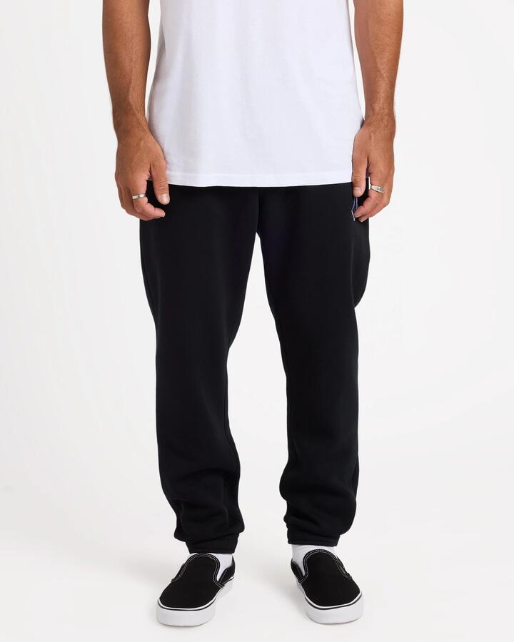 Image of a model wearing Pants. Product name - Volcom Mens Vologo Trackpants Black in Black colour by brand - Volcom