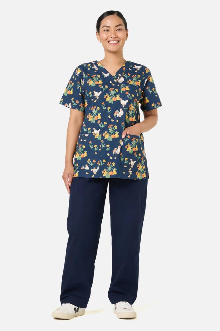 Image of a model wearing Tops. Product name - Chickens Scrub Top &Bottom Set in Navy colour by brand - Scrubs With Love
