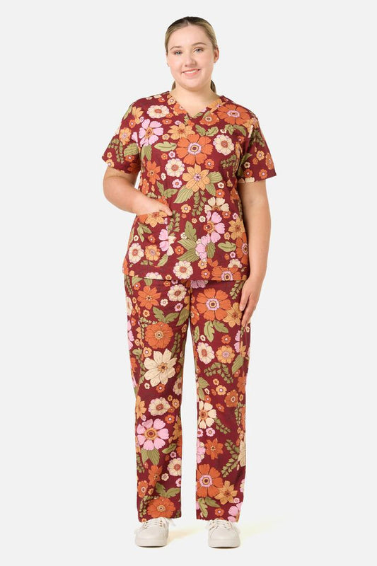 Image of a model wearing Uniforms & Workwear. Productname: Brandy Floral Scrub Set in Rust colour by brand - Scrubs With Love