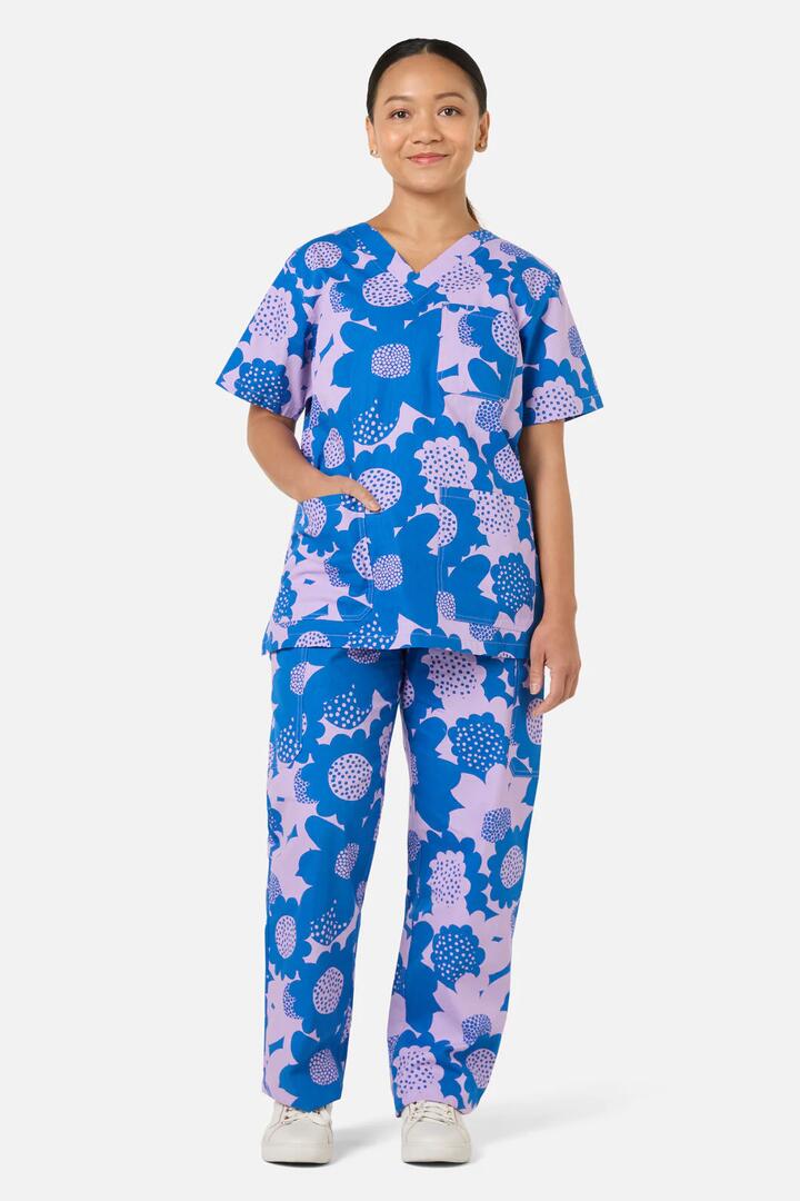 Image of a model wearing Uniforms & Workwear. Product name - Jumbo Flowers Scrub Set in Blue colour by brand - Gorman