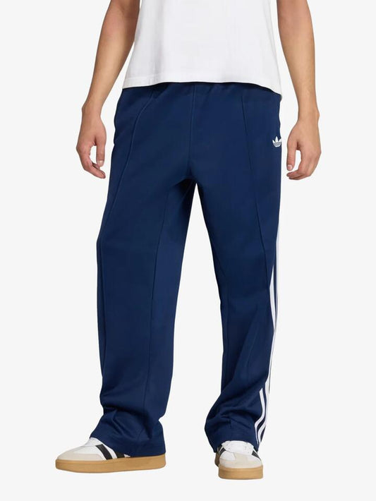 Image of a model wearing Pants. Productname: Adidas Baggy Track Pants in Night Indigo colour by brand - Adidas
