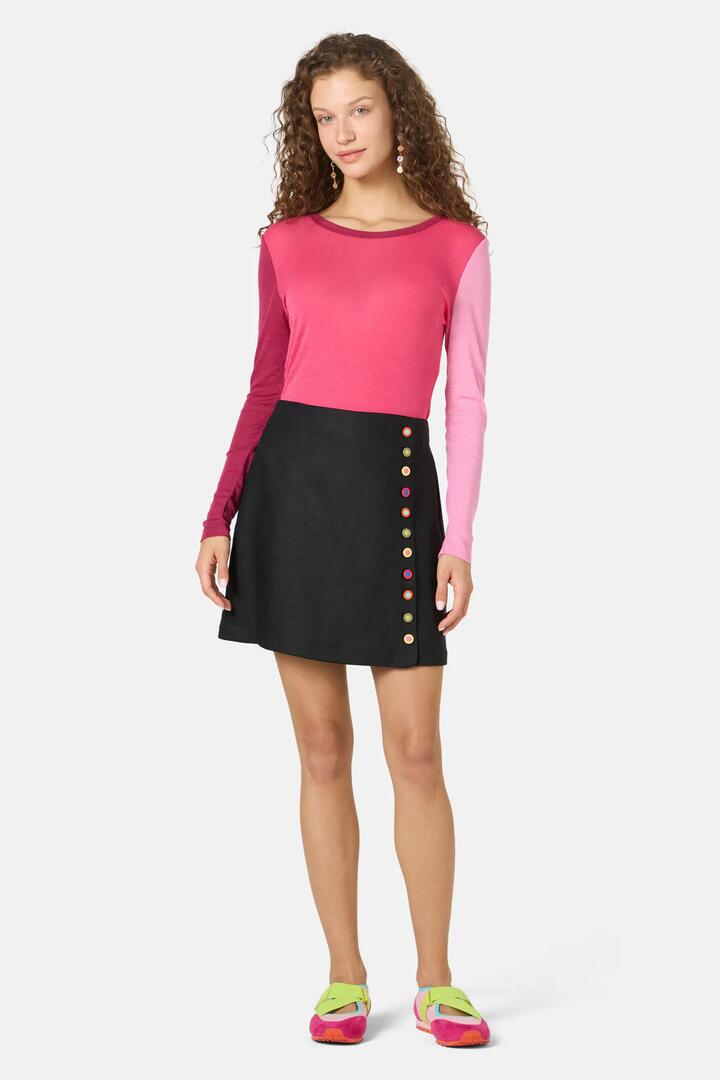 Image of a model wearing Skirts. Product name - Benne Button Mini Skirt in Black colour by brand - Gorman