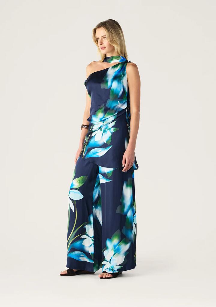 Image of a model wearing Tops. Productname: Bloom Assymetric Top | MOS The Label in Bloom Print colour by brand - MOS The Label