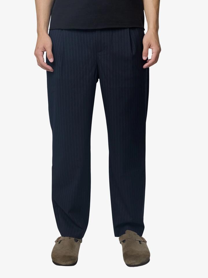Image of a model wearing Pants. Productname: Article One Sleeker Pants in Navy colour by brand - Article One
