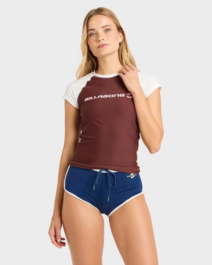 Image of a model wearing Tops. Productname: billabong Womens Supalove Wahine Short Sleeve Rashvest Choc Chip - in Choc Chip colour by brand - Billabong