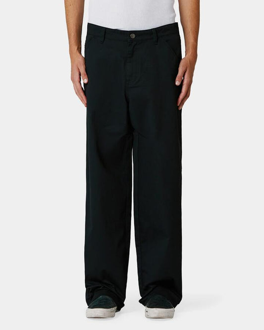 Image of a model wearing Pants. Product name - Former Mens Rynold Work Chino Black in Black colour by brand - Former