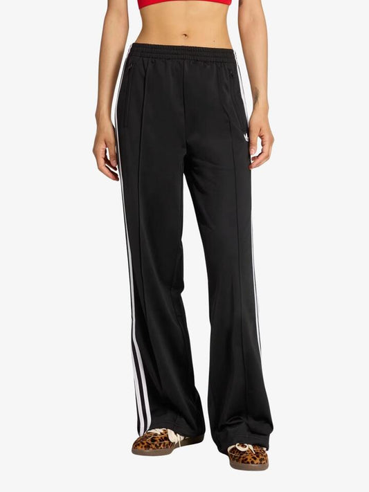 Image of a model wearing Pants. Productname: Adidas Firebird Loose Track Pant in Black/White colour by brand - Adidas