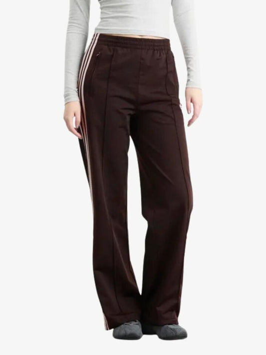 Image of a model wearing Pants. Productname: Adidas Firebird Loose Track Pant in Aurora Coffee/Sandy Pink colour by brand - Adidas