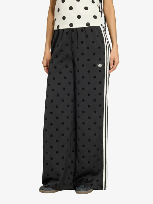 Image of a model wearing Pants. Productname: Adidas Satin Polka Dots Wide Leg Pant in Black colour by brand - Adidas
