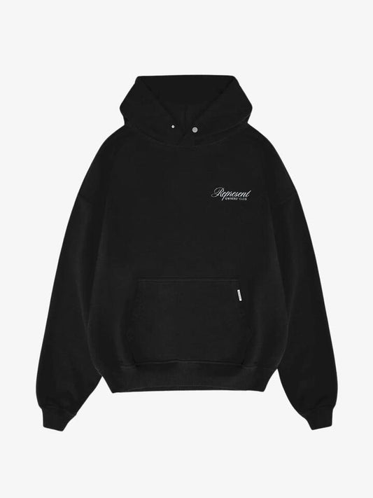 Image of a model wearing Outerwear. Productname: Represent Owners Club Script Hoodie in Black colour by brand - Represent