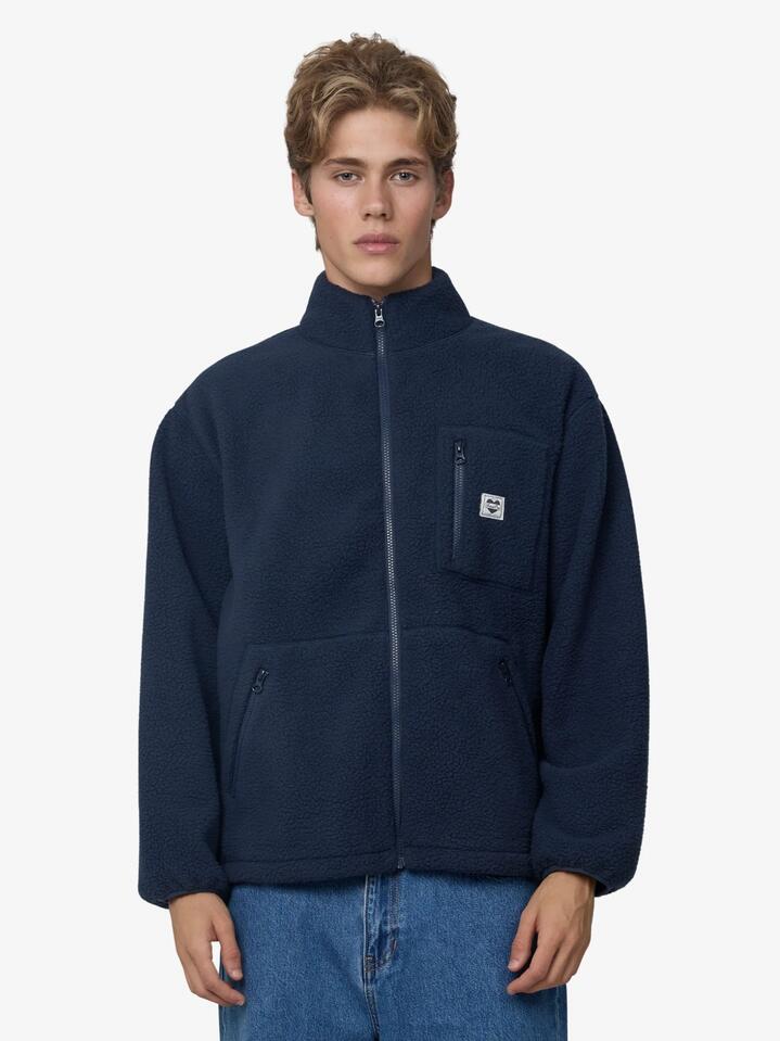 Image of a model wearing Outerwear. Productname: Article One Booth Sherpa Fleece Jacket in Navy colour by brand - Article One