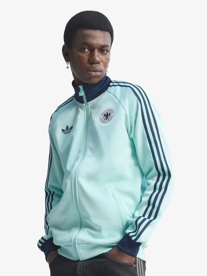 Image of a model wearing Tops. Productname: Adidas Germany Originals Track Top in Semi Flash Aqua colour by brand - Adidas