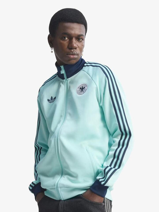 Image of a model wearing Tops. Productname: Adidas Germany Originals Track Top in Semi Flash Aqua colour by brand - Adidas