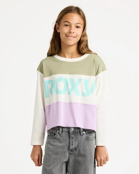 Image of a model wearing Tops. Productname: Roxy Girls 4-16 Sundaze Spirit Long Sleeve T-Shirt Coconut Milk - in Coconut Milk colour by brand - Roxy