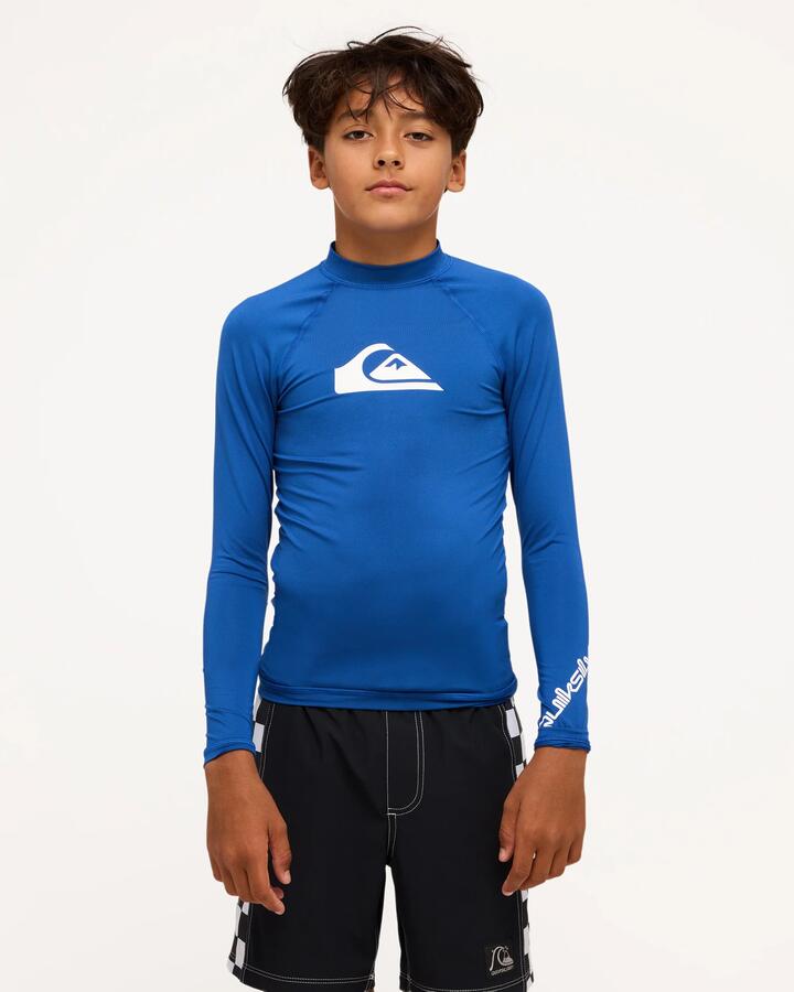 Image of a model wearing Tops. Product name - Quiksilver Boys 8-16 All Time Long Sleeve Id Rashguard Monaco Blue in Monaco Blue colour by brand - Quiksilver