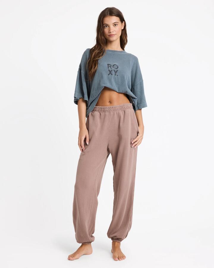 Image of a model wearing Pants. Productname: Roxy Womens Steppin Up Trackpants Mocha - in Mocha colour by brand - Roxy