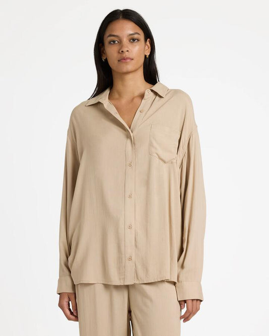 Image of a model wearing Tops. Productname: RVCA Womens Showdown Long Sleeve Shirt Oxford Tan - in Oxford Tan colour by brand - RVCA