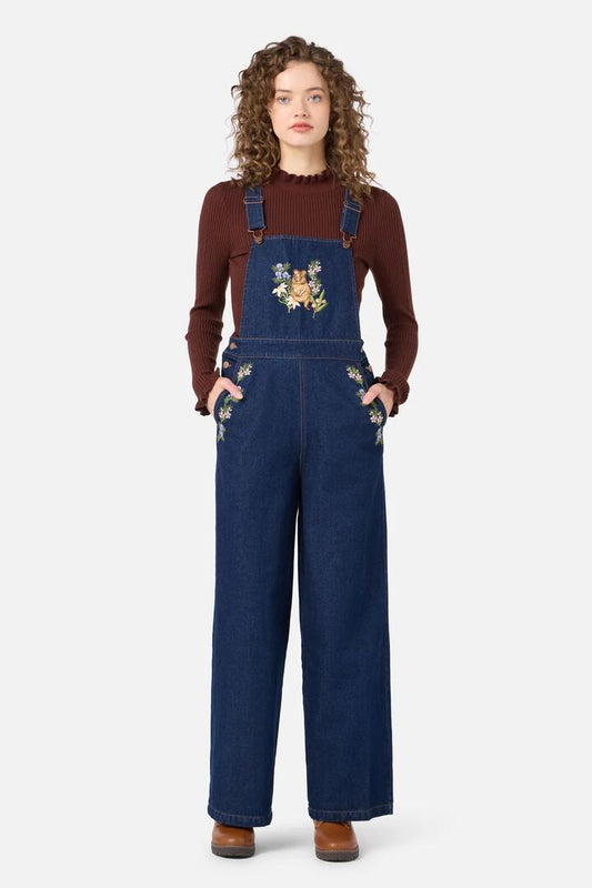 Image of a model wearing Pants. Productname: Quokka Embroidered Overall in Blue Denim colour by brand - Princess Highway