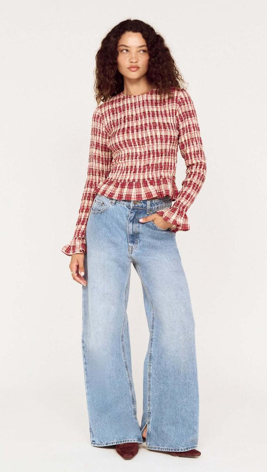Image of a model wearing Pants. Product name - Mid-Rise Slouchy Wide Leg Jeans in Mid Blue colour by brand - MINKPINK