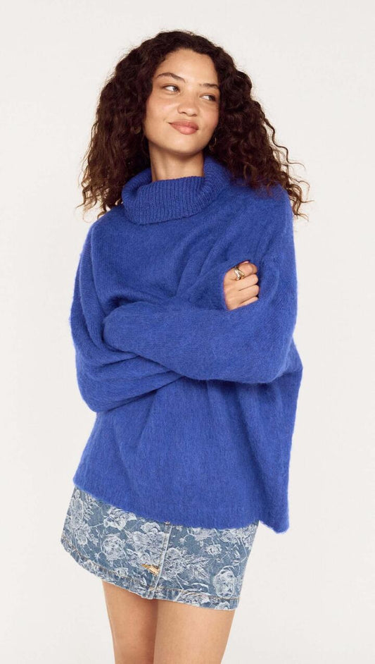 Image of a model wearing Outerwear. Product name - Blue Oversized Roll Neck Jumper in Cobalt Blue colour by brand - MINKPINK