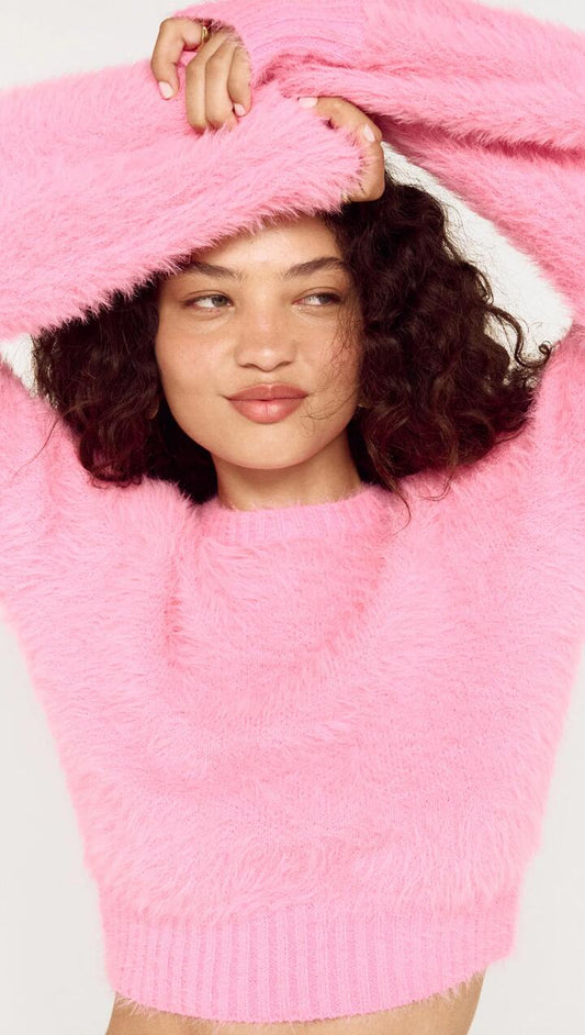 Image of a model wearing Outerwear. Product name - Clio Cropped Fuchsia Pink Fluffy Jumper in Fuchsia colour by brand - MINKPINK
