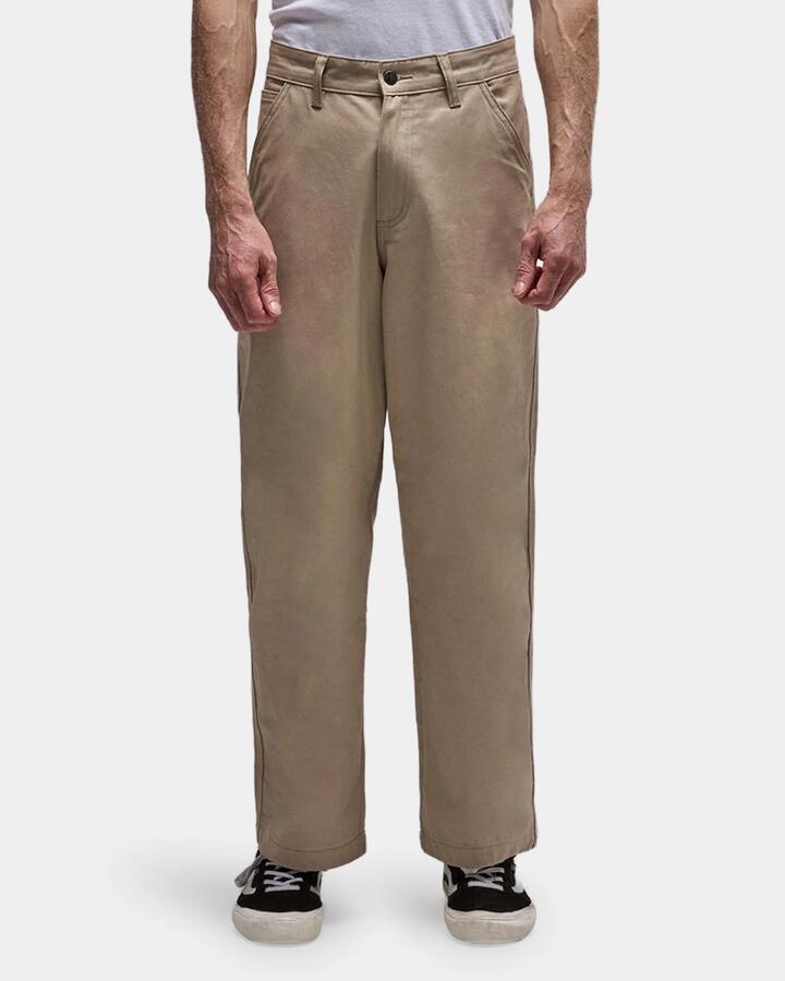 Image of a model wearing Pants. Product name - Former Mens Reynolds Work Pants Stone in Stone colour by brand - Former