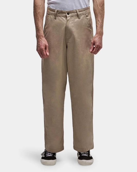 Image of a model wearing Pants. Product name - Former Mens Reynolds Work Pants Stone in Stone colour by brand - Former