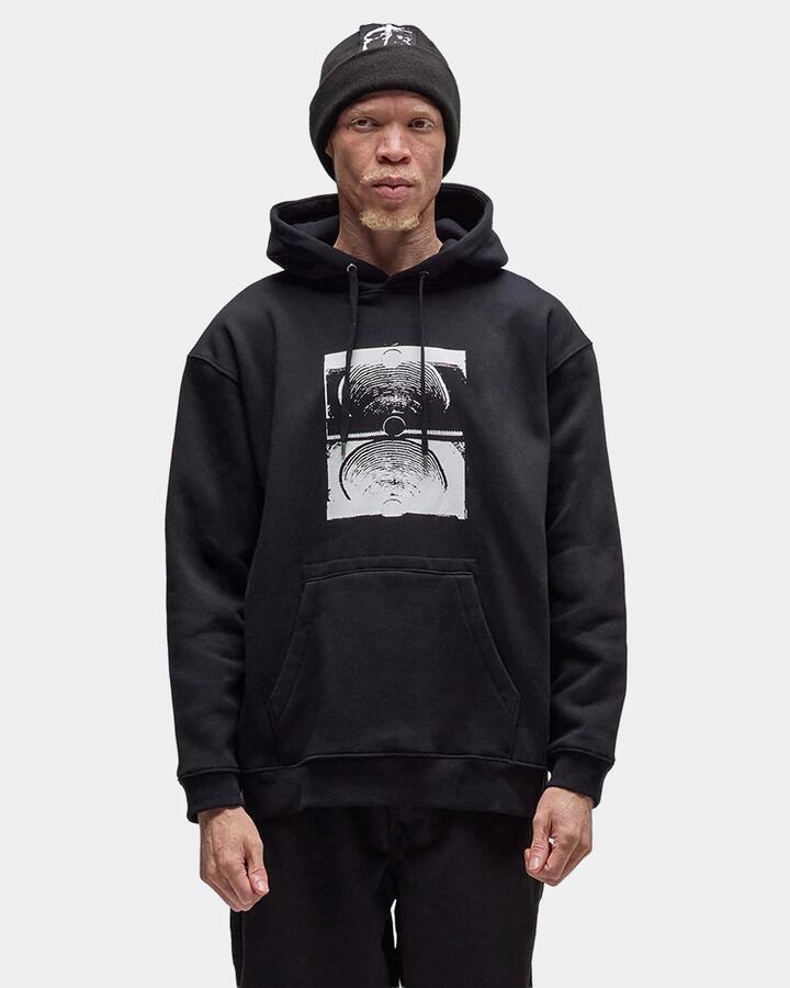Image of a model wearing Outerwear. Product name - Former Mens Crux Pullover Hoodie Black in Black colour by brand - Former