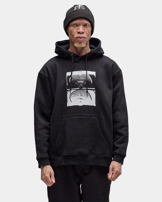 Image of a model wearing Outerwear. Product name - Former Mens Crux Pullover Hoodie Black in Black colour by brand - Former