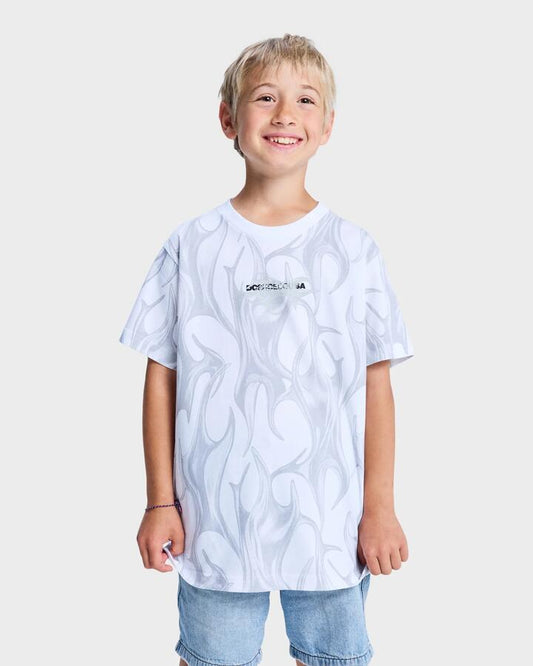 Image of a model wearing Tops. Product name - DC Shoes Boys 10-16 Liquid Fuego Short Sleeve T-Shirt White in White colour by brand - DC Shoes