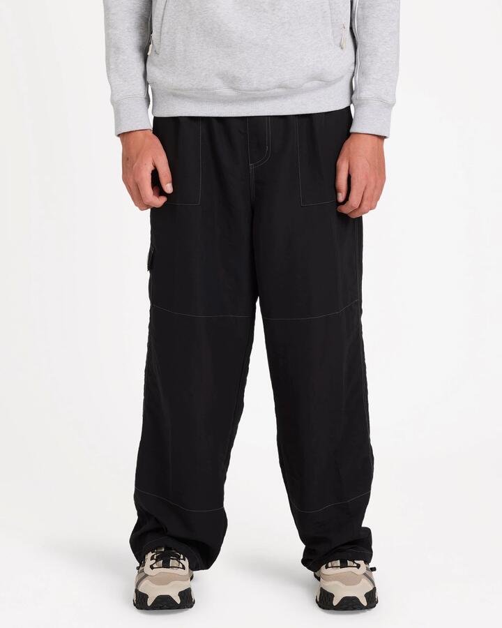 Image of a model wearing Pants. Product name - Billabong Mens Adiv Slant Cargo Pants Black in Black colour by brand - Billabong