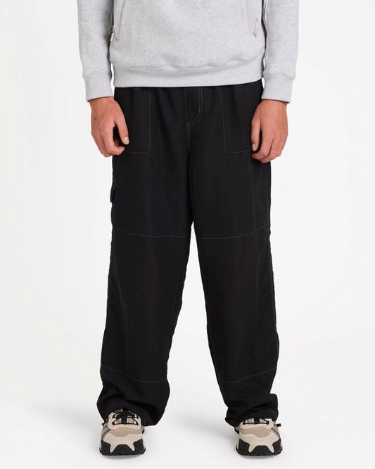 Image of a model wearing Pants. Product name - Billabong Mens Adiv Slant Cargo Pants Black in Black colour by brand - Billabong