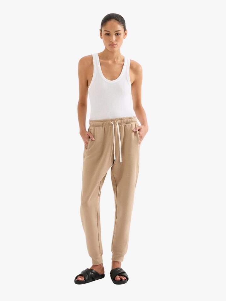 Image of a model wearing Pants. Productname: Nude Lucy Carter Classic Trackpant in Mocha colour by brand - Nude Lucy