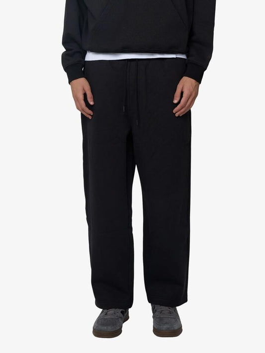 Image of a model wearing Pants. Productname: Article One Evren Track Pants in Washed Black colour by brand - Article One