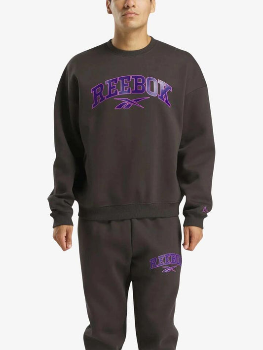 Image of a model wearing Outerwear. Productname: Reebok Curtis Varsity Sweatshirt in Washed Black colour by brand - Reebok