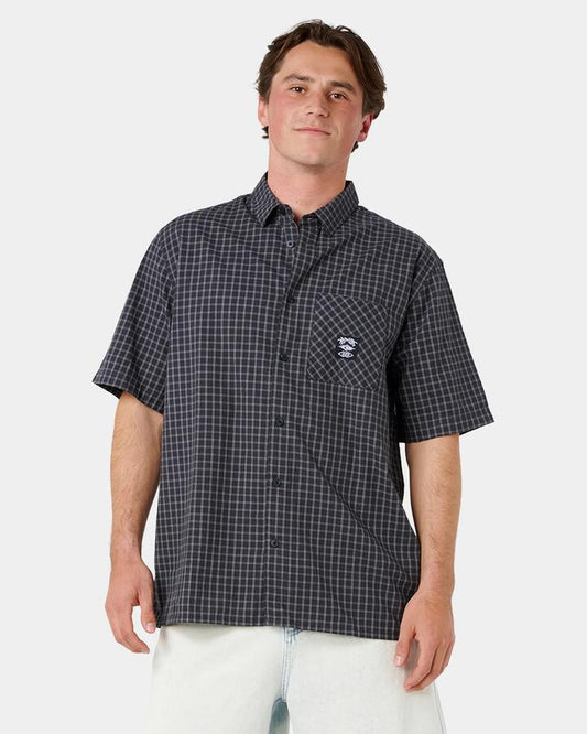 Image of a model wearing Tops. Product name - Rip Curl Mens Liquid Trips Check Short Sleeve Shirt Washed Black in Washed Black colour by brand - Rip Curl