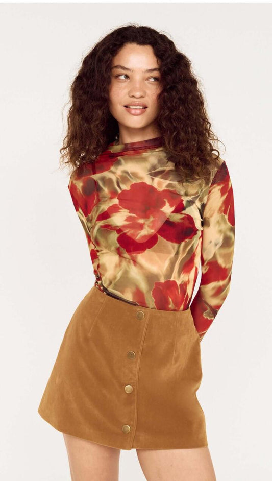 Image of a model wearing Tops. Product name - Red Floral Sheer Mesh High Neck Top in Floral colour by brand - MINKPINK
